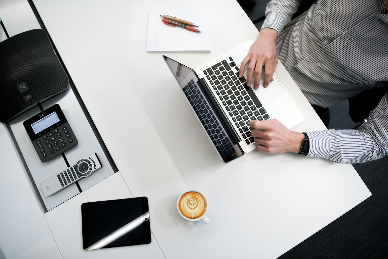 Photo by Tyler Franta person using laptop on white wooden table